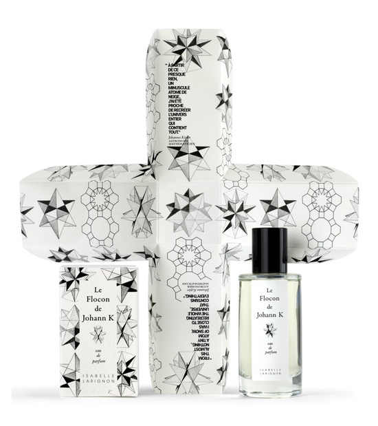 Le Flocon de Johann K by Isabelle Larignon — the 50ml bottle beside its illustrated box, opened out to show the cross-shaped interior printed with snowflake engravings.